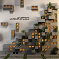 Geometric Wall Design With Gray Blocks Recessed Lights And Green Plants