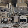 Burned Kitchen After Fire With Charred Cabinets Ovens Stoves Damaged Walls Ceilings And Debris