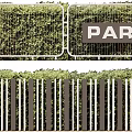 Lush Green Foliage Garden Wall With Vertical Railings And PARK Sign