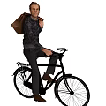 A Man Sitting On Bicycle With Brown Backpack And Casual Attire