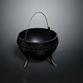 Black Cast Iron Cauldron With Metal Handle And Three Legs Design