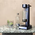 Modern Kitchen Soda Maker On Terrazzo Counter With Glass Lime Slice And Transparent Bottle