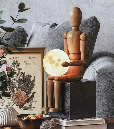 Moon Shaped Decorative Light Held By Wooden Mannequin With Picture Frame Plant And Sofa Background 3d model