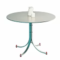 Modern Round Dining Table With Metal Legs And Red Wheels Featuring White Kettle And Cup