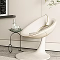 Modern Cream Upholstered Leisure Chair with Curved Backrest Circular Base and Side Table Glassware