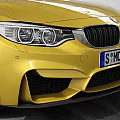 Yellow BMW M4 Coupe Parked In Garage Featuring White Brick Walls High Ceiling Tire Tracks