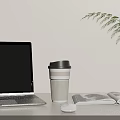Open Laptop On Desk With Coffee Cup Magazine Mouse And Green Plant Leaf