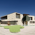 Modern Office Building With Stone Facade Large Windows Balcony And Lush Lawn Trees