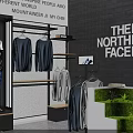 The North Face Clothing Store with Hanging Apparel Poster Display and Green Plants