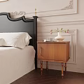 Brown Wooden Nightstand With Gold Handle Cabinet Door And White Vase With Flowers