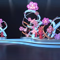 Decorative Art Installations With Pink Flowers Butterflies And Blue Curved Structures On Lit Platform