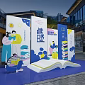 Outdoor Book Themed Installation With People Reading Stacked Books And Open