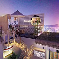 Garden Landscape on Rooftop Terrace with Bamboo Railings Thatched Roof Lanterns and City Night Lights