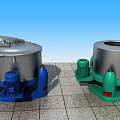 Industrial Centrifugal Dehydrators With Silver Body And Blue Green Bases On Gray Floor Tiles