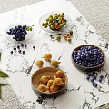 Fresh Blueberries Figs And Grapes In Bowls On Marble Surface With Scattered Fruits