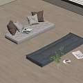 White and Gray Floor Cushions With Pillows Potted Plant And Magazines On Wooden Floor