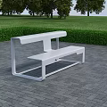 White Metal Roadside Bench On Gray Brick Pavement With Green Lawn Background