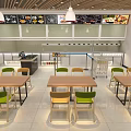 Modern Restaurant Dining Area With Wooden Tables Green Yellow Chairs White Pendant Lights Order Counter