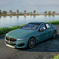Teal Luxury Sedan Parked By Roadside Near Waterfront Palm Trees Grass And Mountains