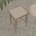Wooden Stool with Woven Seat on Woven Mat Beside Fern Plant