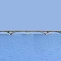 Traditional Stone Arch Bridge With Multiple Arches And Tower Spanning Blue Water