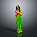 Smiling Woman In Green Sari With Folded Hands On Gray Background