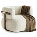 Cream Colored Textured Fabric Armchair With Dark Brown Wooden Armrest And Brown Fringe Blanket