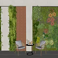 Cozy Leisure Chairs With Small Round Table Against Lush Green Plant Walls In Indoor Space