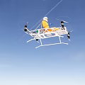 Person In Orange Suit Riding Multi Rotor Flying Vehicle With Propellers