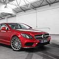 Red Mercedes-Benz Sedan Parked In Spacious Indoor Garage With Tire Tracks On Floor