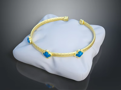 Elegant Gold Textured Bracelet With Blue Gemstones On White Display Cushion 3d model
