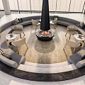 Stylish Circular Lounge Interior With Central Fire Pit Gray Sofas Round Tables And Wooden Floor