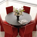 Round Black Dining Table Set with Red Chairs White Purple Flowers Vase Table Mat