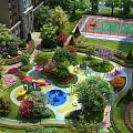 Lush Green Public Square Landscape With Playground Basketball Court And Colorful Flowers