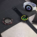 Smart Watches With Black White Straps Green Purple Dials And Case Parts On Desk