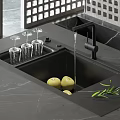 Black Kitchen Sink With Glass Rack Apples And Running Water On Marble Countertop