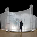 Modern Transparent Curved Exhibition Display With Person Standing And Elements 3d model