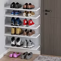Different Colored Shoes On White Shoe Rack With Wooden Door And Carpeted Floor