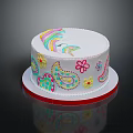 White Round Cake With Colorful Rainbow Flower Paisley Designs And Red Border On Reflective Plate
