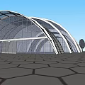 Modern Arched Glass Building With Metal Frame Under Blue Sky And Hexagonal Pavement