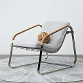 Modern Leisure Chair With Gray Cushion Wooden Armrests Metal Frame And Knotted Decor On Rug