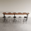 Modern Long Wooden Dining Table with Black and Metallic Stools and White Plates