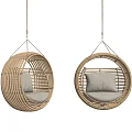Set of Two Rattan Round Hanging Chairs With Soft Cushions In Light Background