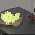 Green Grapes on Wooden Plate and Dark Cherries in Glass Bowl on Gray Table