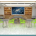 Modern Front Desk Reception Area With Green Chairs Round Tables And Large Screen