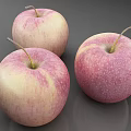 Three Fresh Apples with Pink and White Skin on a Smooth Gray Surface Looking Juicy