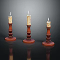 Three Ornate Candle Holders With Lit Candles Red Bases And Carved Details On Dark Surface