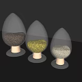 Three Transparent Teardrop Shaped Ceramic Vessels With Golden Base And Decorative Granules