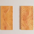 Two Orange Wavy Carved Wall Decor Pieces on Light Colored Wall