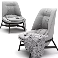 Gray Leisure Chair with High Back Pleated Plush Cushion Dark Wooden Legs and Patterned Blanket